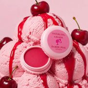 Barbie Pink lip balm with pink ice cream and cherries on a pink background