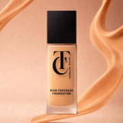 Foundation bottle with a swatch of foundation on a peach background