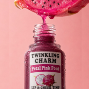 Bottle of 'Twinkling Charm Petal Pink Pout' lip and cheek tint with dragon fruit slice on pink background