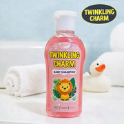 Pink bottle of Twinkling Charm baby shampoo with a lion graphic on a light blue background.