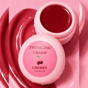 Pink lip balm container with cherry design on a pink background