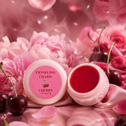 Pink lip balm with cherry flavor on a pink floral background