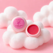 Pink lip balm with a cloud-shaped container on a pink background