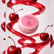 Pink lip balm with cherry design surrounded by red cherries and syrup on a light pink background