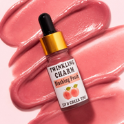Lip tint bottle labeled 'Twinkling Charm Blushing Peach' on a pink background