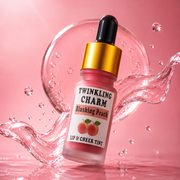 Lip and cheek tint bottle labeled 'Twinkling Charm Blushing Peach' on a pink background with water droplets.