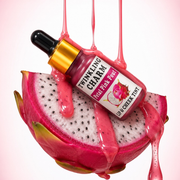 Twinkling Charm lip and cheek tint bottle inside a dragon fruit with pink liquid dripping.