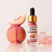 Lip and cheek tint bottle labeled 'Twinkling Charm' with a peach and peach slices on a light background