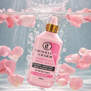 Pink facial wash bottle with water and pink petals in the background