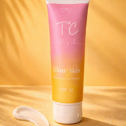 Tube of 'TC' Glow Skin sunscreen with a gradient design on a yellow background