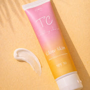Tube of 'TC Glow Skin' sunscreen with a gradient design on a yellow background